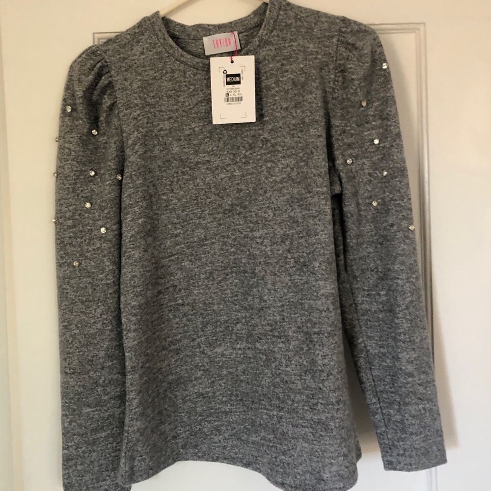 Grey sweater with embellishment on sleeves.